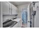 Bright laundry room features modern washer and dryer and storage cabinets at 1010 Flanders St, Garner, NC 27529