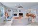 Cozy living room features a brick fireplace, ceiling fan, and neutral-toned furniture for comfortable living at 1010 Flanders St, Garner, NC 27529