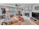 Comfortable living room featuring a brick fireplace, carpet floors, and a large window for ample natural light at 1010 Flanders St, Garner, NC 27529