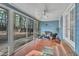 Cozy screened-in porch with comfortable wicker furniture and serene views of the wooded backyard at 1010 Flanders St, Garner, NC 27529