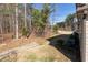 Expansive backyard featuring a slope, a rock drainage ditch, and privacy from mature trees at 1012 Catch Fly Ln, Durham, NC 27713