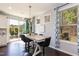 Sunlit dining room featuring sliding glass doors to the patio and a view of the landscaped yard at 1012 Catch Fly Ln, Durham, NC 27713