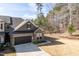 Stylish townhome boasting stone and shingle siding, a two-car garage, and an easy-to-maintain lawn at 1012 Catch Fly Ln, Durham, NC 27713