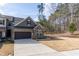 Beautiful townhome showcasing stone accents, a two-car garage, and a well-maintained lawn at 1012 Catch Fly Ln, Durham, NC 27713