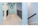 Hallway featuring wrought iron railing, neutral carpet, and light blue paint at 1012 Catch Fly Ln, Durham, NC 27713