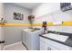 Functional laundry room with modern washer and dryer, utility sink, and ample storage space at 1012 Catch Fly Ln, Durham, NC 27713