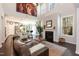 Bright and airy living room with a fireplace, large windows, and an open concept design with an adjacent kitchen at 1012 Catch Fly Ln, Durham, NC 27713