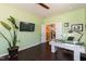Spacious home office with a glass desk and a view of the doorway at 1012 Catch Fly Ln, Durham, NC 27713
