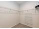 Walk-in closet with ample shelving and a sleek, organized layout for optimal storage at 1012 Catch Fly Ln, Durham, NC 27713