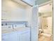 Bathroom adjoins laundry area with full-size washer and dryer for convenient living at 103 Morningside Dr, Carrboro, NC 27510