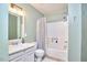Well-lit bathroom with a shower-tub combo and a classic vanity with a large mirror at 103 Morningside Dr, Carrboro, NC 27510
