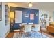 Dining room area featuring a table with four chairs, a modern light fixture, and artwork at 103 Morningside Dr, Carrboro, NC 27510