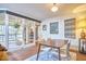 View of the dining room featuring a table and chairs, brick floors, and a view to the exterior at 103 Morningside Dr, Carrboro, NC 27510