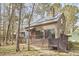 Charming home featuring wood siding, a cozy front porch, and a surrounding forest setting at 103 Morningside Dr, Carrboro, NC 27510