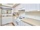 Kitchen with white cabinets and tile backsplash at 103 Morningside Dr, Carrboro, NC 27510