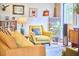 Bright living room with yellow armchair and plants at 103 Morningside Dr, Carrboro, NC 27510