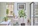 View of the sunroom area featuring plants, a small window, and a large fiddle leaf fig tree at 103 Morningside Dr, Carrboro, NC 27510