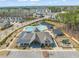 Community clubhouse with a pool, playground, and ample parking, set amidst lush greenery at 1121 White Oak Creek Dr, Apex, NC 27523