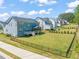 Spacious fenced backyard featuring lush green grass and a screened porch, perfect for outdoor enjoyment at 1121 White Oak Creek Dr, Apex, NC 27523