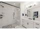 This modern bathroom features a walk-in shower with tiled walls and a sleek glass door at 1121 White Oak Creek Dr, Apex, NC 27523