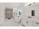 Bright bathroom features marble floors, a soaking tub under window, and glass shower with sleek fixtures at 1121 White Oak Creek Dr, Apex, NC 27523