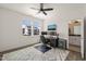 Bedroom with work-space features a ceiling fan, large window, and modern decor at 1121 White Oak Creek Dr, Apex, NC 27523