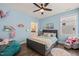 Cozy blue bedroom features a gray bed with hardwood floors and many kid-friendly decorations at 1121 White Oak Creek Dr, Apex, NC 27523