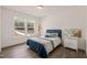 Cozy bedroom boasts hardwood floors, natural light, and a comfortable bed with stylish decor at 1121 White Oak Creek Dr, Apex, NC 27523