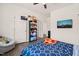 Hardwood floored bedroom features a chair, bed with a pizza blanket, and a large shelf of stuffed animals at 1121 White Oak Creek Dr, Apex, NC 27523