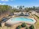 Aerial view of the community pool and clubhouse amenities in a wooded setting at 1121 White Oak Creek Dr, Apex, NC 27523