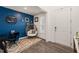Bright entry featuring a blue accent wall, decor, unique seat and warm-toned flooring at 1121 White Oak Creek Dr, Apex, NC 27523