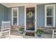 Close-up of the inviting front door, adorned with a floral wreath and planters at 1121 White Oak Creek Dr, Apex, NC 27523