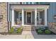 Charming front porch with rocking chairs, brick accents, and inviting curb appeal at 1121 White Oak Creek Dr, Apex, NC 27523