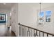 Hallway featuring a stylish light fixture and bright windows at 1121 White Oak Creek Dr, Apex, NC 27523
