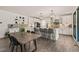 Open-concept kitchen featuring a large island, white cabinets, and modern fixtures at 1121 White Oak Creek Dr, Apex, NC 27523