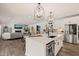 Stylish kitchen with white cabinetry, hardwood floors, and an open view to the living room at 1121 White Oak Creek Dr, Apex, NC 27523