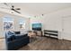 Living area features a ceiling fan, hardwood floors, and modern decor with a TV at 1121 White Oak Creek Dr, Apex, NC 27523