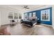 Spacious main bedroom with tray ceiling, hardwood floors, and a bright blue accent wall at 1121 White Oak Creek Dr, Apex, NC 27523