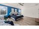 Main bedroom with blue accent wall, tray ceiling, sitting area, and hardwood style floors at 1121 White Oak Creek Dr, Apex, NC 27523