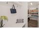 Mudroom with coat hooks, bench, and doorway view into a fully stocked pantry at 1121 White Oak Creek Dr, Apex, NC 27523