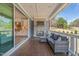 Cozy covered deck with stone fireplace, outdoor seating, and views into the open kitchen at 1121 White Oak Creek Dr, Apex, NC 27523