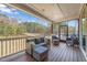 Relaxing screened porch with comfortable outdoor seating and wooded views at 1121 White Oak Creek Dr, Apex, NC 27523