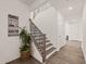 Staircase featuring modern railing design and warm-toned floors with a plant at 1121 White Oak Creek Dr, Apex, NC 27523