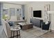 Cozy living room featuring stylish sofas, contemporary art, and large windows for natural light at 1130 Winding Spring Dr, Mebane, NC 27302