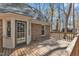 Exterior view of wooden deck attached to brick house with lush trees in the background at 1133 Turner Farms Rd, Garner, NC 27529
