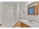 Bathroom features a white shower, toilet, vanity, and wooden framed mirror and towel rack at 1133 Turner Farms Rd, Garner, NC 27529