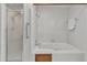 Bright bathroom featuring a shower with glass door and separate tub for relaxation at 1133 Turner Farms Rd, Garner, NC 27529