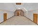 Spacious bonus room with neutral carpet, sky light, and doors leading to additional rooms at 1133 Turner Farms Rd, Garner, NC 27529