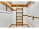 Walk-in closet with wood shelving and hanging rods, providing ample storage space at 1133 Turner Farms Rd, Garner, NC 27529