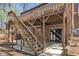 Brick home with wood deck and stairs leading to the lower level concrete patio and backyard at 1133 Turner Farms Rd, Garner, NC 27529